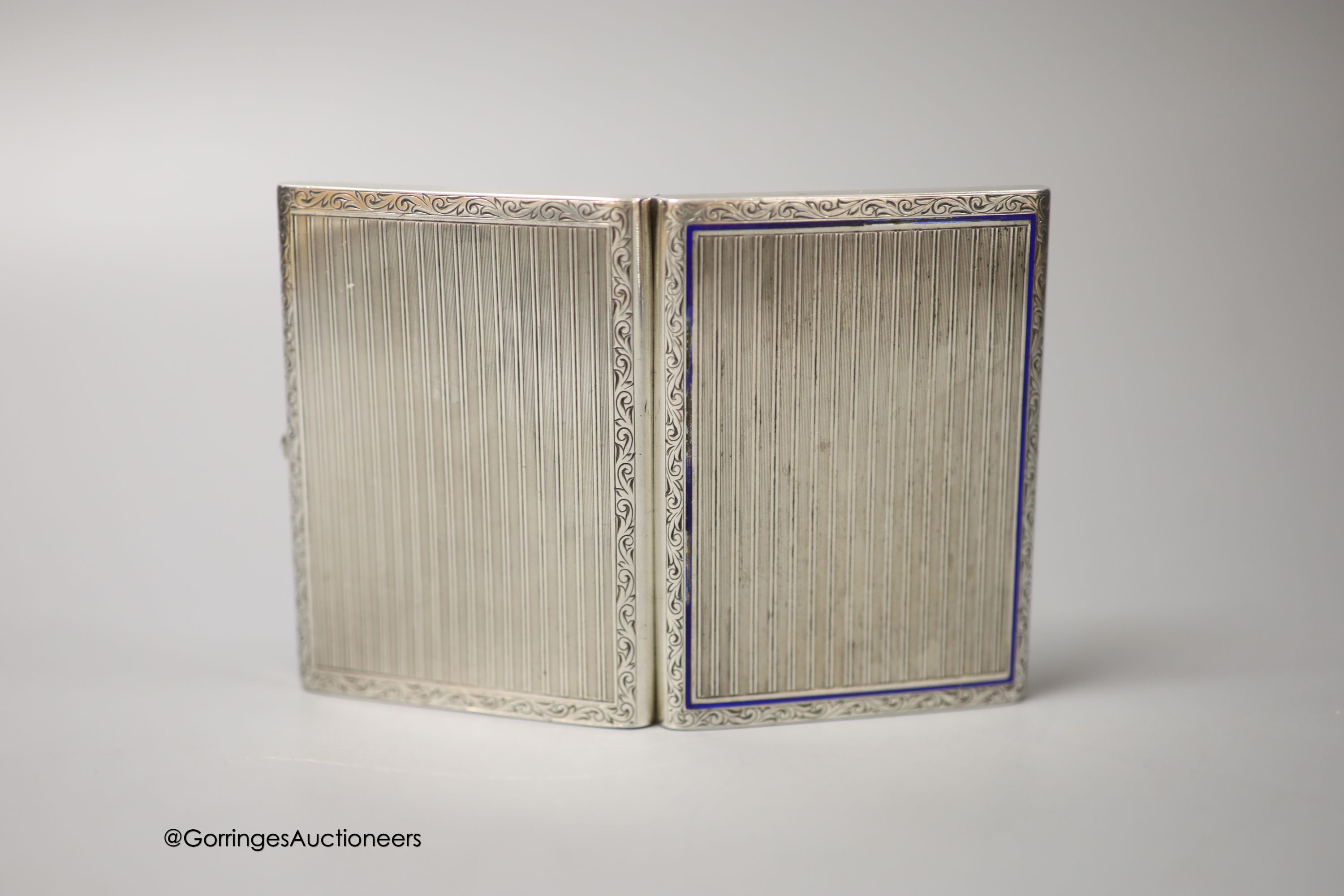 A German 935 white metal and enamel cigarette case, with interior inscription, 'In gratitude For Your Sincere Friendship, The Jewish Community, Luneberg, January, 1948', 87mm, together with a base metal cigar cutter and
